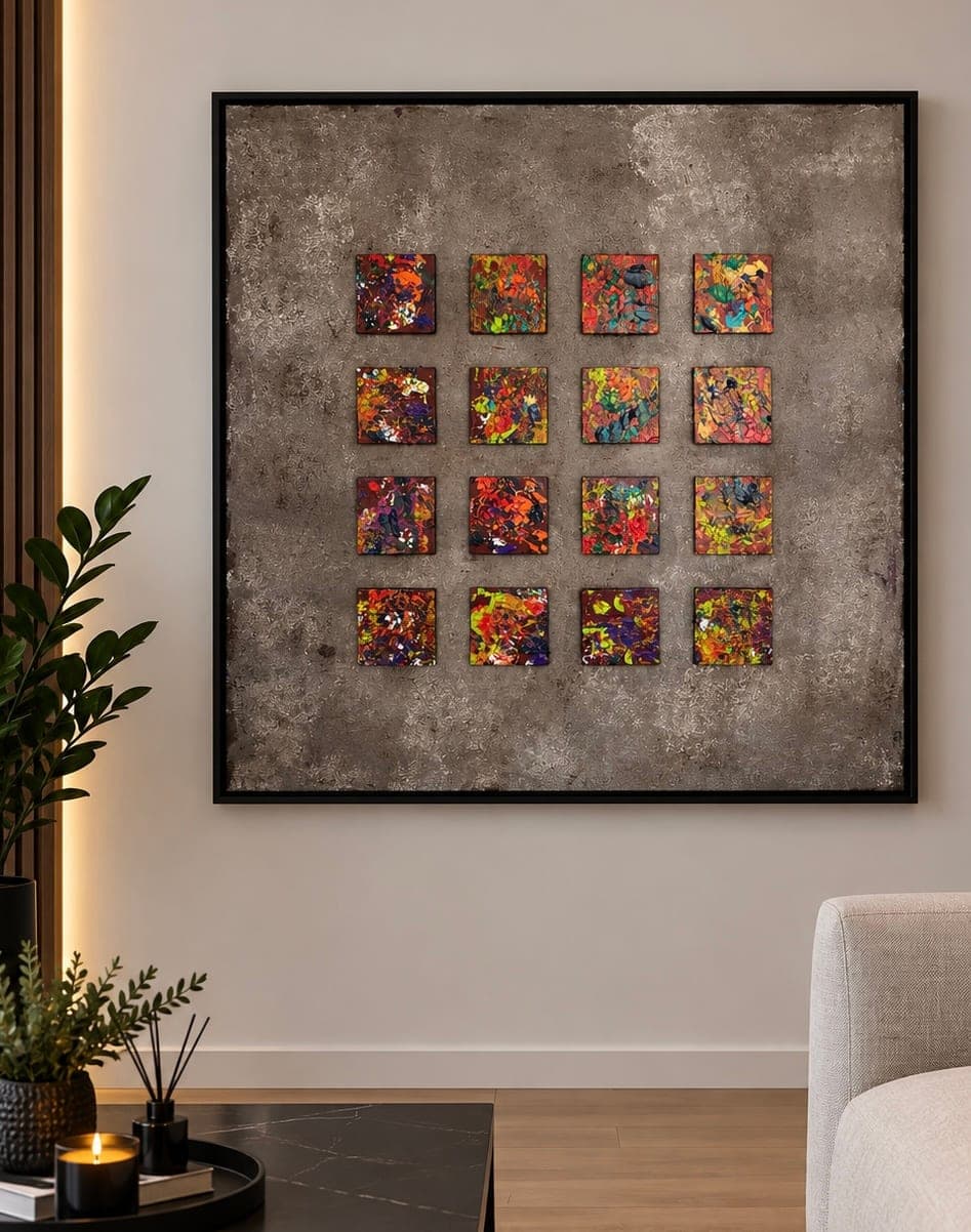 Square abstract painting of sixteen small vivid panels in orange, yellow, blue and green, set in a four-by-four grid on a textured bronze-grey ground, in a black float frame.